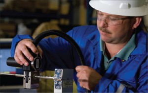 A Schlumberger operator splices an electric cable with the Intellitite connector. The nonwelded connector incorporates independent, redundant metal-to-metal seals and a cable-anchoring device to isolate the seal from any mechanical loading. During installation, seals are tested using a microleak detection system. Source: Schlumberger