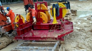 Workers assemble the crown block of Tuscany International Drilling’s self-erecting drilling system rig. The Amazon’s rainy season, which runs from October through June, created challenging work conditions.