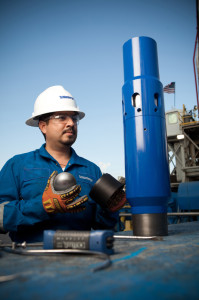 A Schlumberger engineer performs quality assurance verification on the Falcon multistage stimulation system for uncemented wells. The ball shown is the new ELEMENTAL high-performance degradable alloy ball.