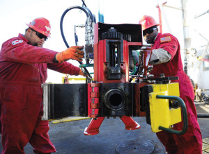 Only two members of the rig crew are needed to either attach or detach the clamp. One crew member would operate the hydraulic cylinder to adjust the height while the other would guide the side flow pipe to the sub for clamping.