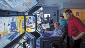 John Ash (center), Assistant Rig Manager for the Noble Mick O’Brien, uses the drilling simulator at Noble’s NEXT Center near Houston. Noble uses simulator-based training to coach employees in skills such as listening, communication and stress management. 