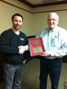 Joe Hurt presents a chairman’s plaque to Hodges Trucking’s Justin Hodges