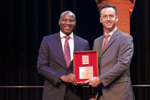 IADC President Jason McFarland (right) presents the IADC Exemplary Service Award to Sola Falodun, General Manager, Drilling and Completion Systems for OES Energy Services.